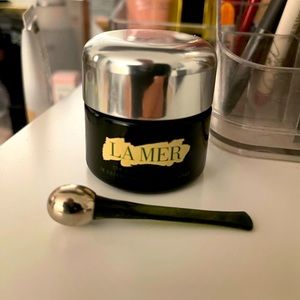 Empty La Mer eye cream container, cooling massage applicator and box